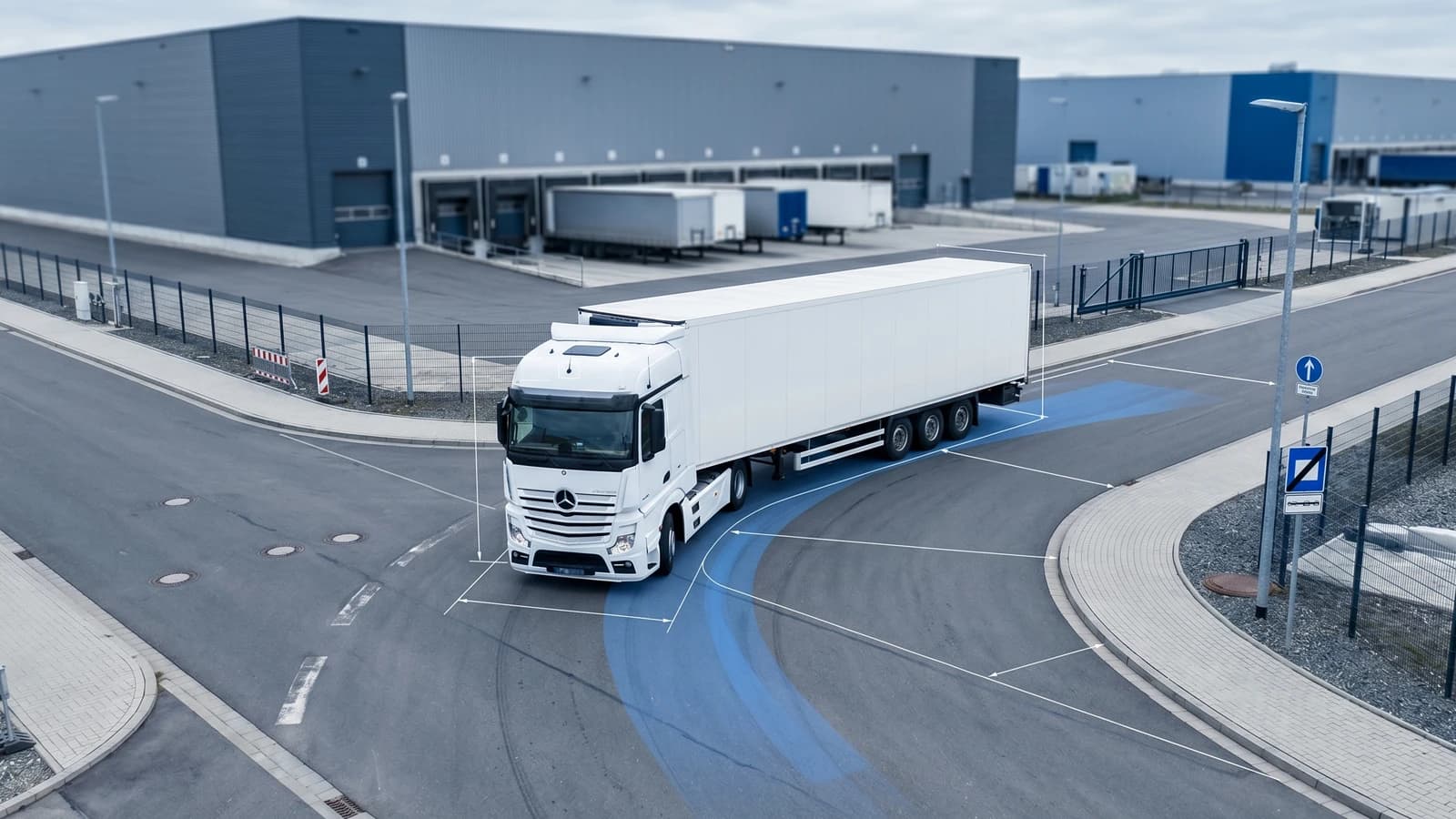 European semi-trailer truck negotiating a 90-degree turn with visible swept path off-tracking